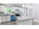 Bright kitchen featuring granite countertops, modern appliances, a kitchen island, and plenty of cabinet space at 3017 Tribble Ln, Atlanta, GA 30311