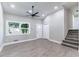 Inviting living room with a modern ceiling fan, bright lighting, new floors, and an open layout to the kitchen at 3017 Tribble Ln, Atlanta, GA 30311