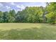Large, grassy backyard with mature trees, providing ample space for recreation and relaxation at 3600 Anglin Rd, Loganville, GA 30052