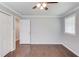 Cozy bedroom boasts hardwood floors, ceiling fan, and neutral color palette with closet at 3600 Anglin Rd, Loganville, GA 30052