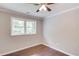 Cozy bedroom boasts hardwood floors, ceiling fan, and window at 3600 Anglin Rd, Loganville, GA 30052