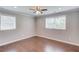 Empty bedroom with hardwood floors, overhead fan and two windows at 3600 Anglin Rd, Loganville, GA 30052