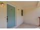 Close-up of front porch featuring a vibrant turquoise door and classic sconce lighting at 3600 Anglin Rd, Loganville, GA 30052