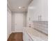 Kitchen features white cabinetry, granite countertops and tile backsplash at 3600 Anglin Rd, Loganville, GA 30052