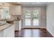 Bright kitchen area features stainless sink, granite countertops, access to the outdoor deck, and hardwood floors at 3600 Anglin Rd, Loganville, GA 30052