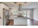 Bright kitchen features stainless appliances, granite countertops and island with cooktop, and hardwood floors at 3600 Anglin Rd, Loganville, GA 30052