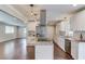 Spacious kitchen with stainless appliances, granite countertops and island with cooktop, and hardwood floors at 3600 Anglin Rd, Loganville, GA 30052