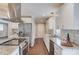 Kitchen boasts stainless appliances, granite countertops, tiled backsplash, and hardwood floors at 3600 Anglin Rd, Loganville, GA 30052