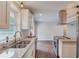 Well-lit kitchen with stainless sink, granite countertops, and hardwood floors at 3600 Anglin Rd, Loganville, GA 30052