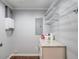Functional laundry room includes shelving, granite countertop, utility sink hookups, and gray walls at 3600 Anglin Rd, Loganville, GA 30052