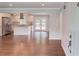 Open-concept space flows into a modern kitchen with stainless steel appliances at 3600 Anglin Rd, Loganville, GA 30052