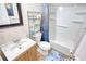 Compact bathroom with a sink, toilet, and bathtub; a decorative blue curtain adds style to the space at 4180 Mount Paran Dr, Social Circle, GA 30025