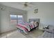 Cozy bedroom with a queen bed, large window letting in natural light, and a serene outdoor view at 4180 Mount Paran Dr, Social Circle, GA 30025