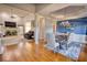 Elegant dining area with hardwood floors and an exquisite chandelier, complemented by views into the spacious living room at 4180 Mount Paran Dr, Social Circle, GA 30025