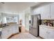 Bright kitchen with white cabinets, a stainless steel refrigerator, and natural light, offering a clean and inviting space at 4180 Mount Paran Dr, Social Circle, GA 30025