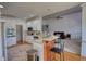 Open kitchen featuring stainless appliances, white cabinets, and an adjacent living area perfect for modern living and entertaining at 4180 Mount Paran Dr, Social Circle, GA 30025