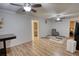 Open concept living room with hardwood floors, light neutral paint, and a ceiling fan; decorated simply at 4180 Mount Paran Dr, Social Circle, GA 30025