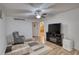 Comfortable living area featuring a TV, recliner, and a modern ceiling fan providing ample lighting at 4180 Mount Paran Dr, Social Circle, GA 30025