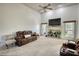 Spacious living room featuring a cozy fireplace, large TV, and comfortable seating, ideal for relaxing and entertaining at 4180 Mount Paran Dr, Social Circle, GA 30025