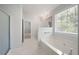 Bright bathroom featuring a soaking tub, tiled floors, and a separate shower area at 45 Waterloo Ct, Hiram, GA 30141