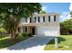 Two story home with black shutters, light siding, and well manicured lawn and front yard at 45 Waterloo Ct, Hiram, GA 30141