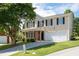 Two-story home with light yellow siding, black shutters, an attached two-car garage, and a well-manicured lawn at 45 Waterloo Ct, Hiram, GA 30141