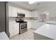 Kitchen features white cabinets, stainless steel appliances, and tiled backsplash at 45 Waterloo Ct, Hiram, GA 30141