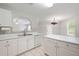 This kitchen features white cabinets, updated appliances, and tiled backsplash at 45 Waterloo Ct, Hiram, GA 30141