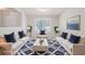 Staged living room with matching white sofas, navy cushions, and blue patterned rug at 45 Waterloo Ct, Hiram, GA 30141