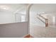 Open-concept living area with neutral tile flooring, archway, and staircase with wooden railing at 45 Waterloo Ct, Hiram, GA 30141