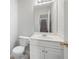 This powder room features a white vanity, toilet, and large mirror at 45 Waterloo Ct, Hiram, GA 30141