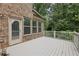 Spacious back deck with stairs, wood railing and brick on the back of the house at 1136 Garner Creek At Parkview Sw Dr, Lilburn, GA 30047
