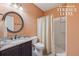 Terrace level bathroom with a shower and a decorative round mirror over the sink at 1136 Garner Creek At Parkview Sw Dr, Lilburn, GA 30047