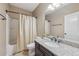 Well-lit bathroom with a single sink vanity, granite countertop, and shower-tub combo at 1136 Garner Creek At Parkview Sw Dr, Lilburn, GA 30047