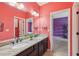 Double vanity bathroom with granite countertops, large mirrors, and colorful walls at 1136 Garner Creek At Parkview Sw Dr, Lilburn, GA 30047