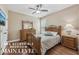 Comfortable bedroom with a dresser, queen bed, and wood floors at 1136 Garner Creek At Parkview Sw Dr, Lilburn, GA 30047
