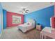 Bright bedroom features colorful walls, carpeted floors, a ceiling fan, and lots of natural light at 1136 Garner Creek At Parkview Sw Dr, Lilburn, GA 30047