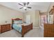Inviting bedroom features a ceiling fan, carpeted floors, and wood furniture at 1136 Garner Creek At Parkview Sw Dr, Lilburn, GA 30047