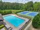 Aerial view of a community pool and tennis courts surrounded by lush greenery, offering recreational opportunities at 1136 Garner Creek At Parkview Sw Dr, Lilburn, GA 30047