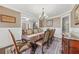 Formal dining room with wainscoting, hardwood floors, and chandelier lighting at 1136 Garner Creek At Parkview Sw Dr, Lilburn, GA 30047