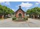 Community entrance gatehouse with brick facade and manicured landscaping, providing a secure and welcoming entry at 1136 Garner Creek At Parkview Sw Dr, Lilburn, GA 30047