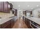 Spacious kitchen with dark wood cabinetry, granite countertops, stainless steel appliances, and hardwood floors at 1136 Garner Creek At Parkview Sw Dr, Lilburn, GA 30047