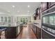 Open kitchen featuring an island with seating, stainless appliances, and granite countertops at 1136 Garner Creek At Parkview Sw Dr, Lilburn, GA 30047