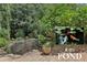 Backyard koi pond surrounded by lush greenery, offering a serene outdoor retreat, inset shows koi fish in the pond at 1136 Garner Creek At Parkview Sw Dr, Lilburn, GA 30047