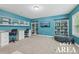 Bright loft area features built-in desks and shelving with blue walls and neutral carpeting at 1136 Garner Creek At Parkview Sw Dr, Lilburn, GA 30047