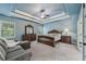 Spacious main bedroom featuring a sitting area, windows, and a decorative tray ceiling at 1136 Garner Creek At Parkview Sw Dr, Lilburn, GA 30047