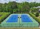 Aerial view of the community tennis courts surrounded by greenery, providing a space for active recreation at 1136 Garner Creek At Parkview Sw Dr, Lilburn, GA 30047