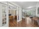 Inviting living space with hardwood floors, an adjacent office through French doors, and staircase access at 1136 Garner Creek Sw Dr, Lilburn, GA 30047