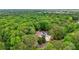 Stunning aerial view of a spacious home with a well-manicured lawn, surrounded by lush trees at 400 N Peachtree Pkwy, Peachtree City, GA 30269