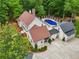 Serene backyard with in-ground pool, well-maintained lawn and a trampoline, surrounded by lush greenery and mature trees at 400 N Peachtree Pkwy, Peachtree City, GA 30269